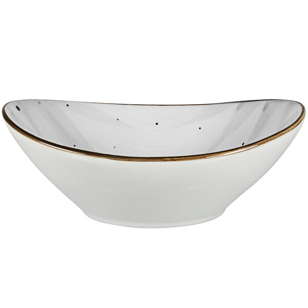 A white International Tableware oval porcelain bowl with a gold rim.