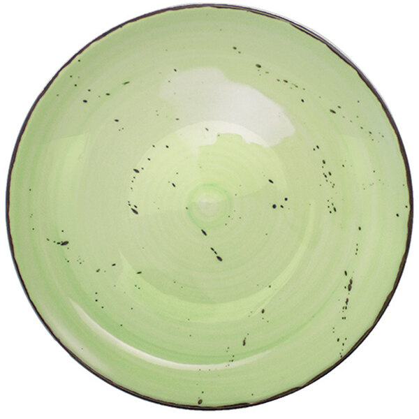 A lime green porcelain bowl with black speckles.
