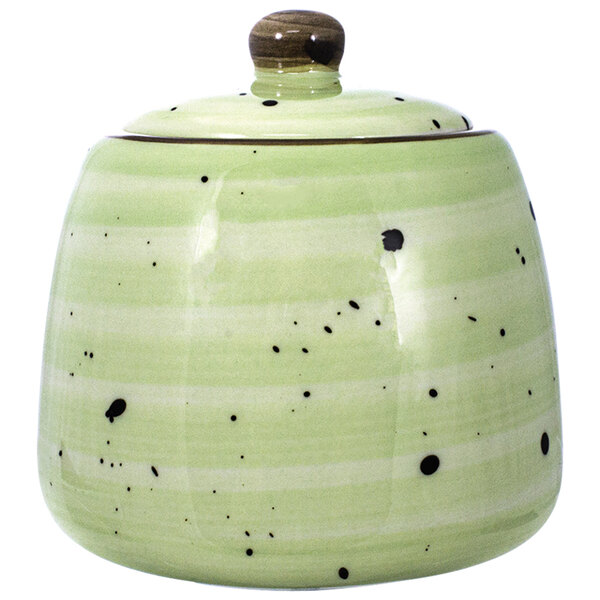 An International Tableware lime porcelain sugar dish with a lid with a green and black speckled design.