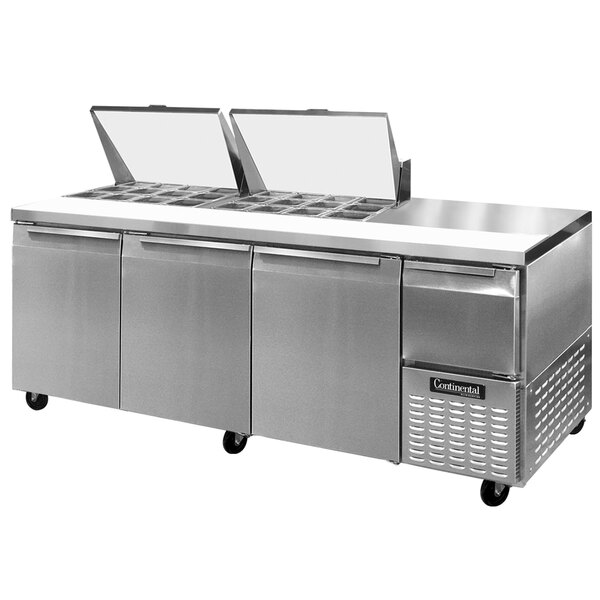 A Continental Refrigerator stainless steel food prep table with three trays.