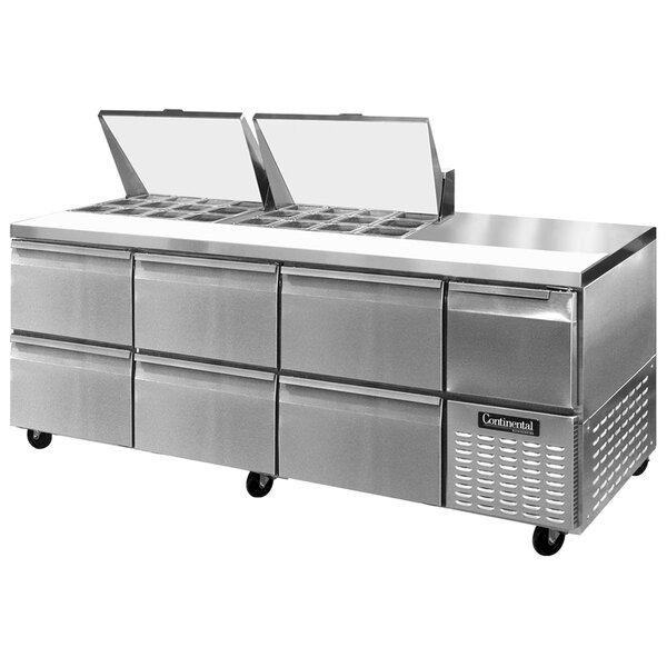 A stainless steel Continental Refrigerator food prep table with six drawers.