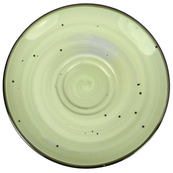 A white porcelain saucer with black dots on it.