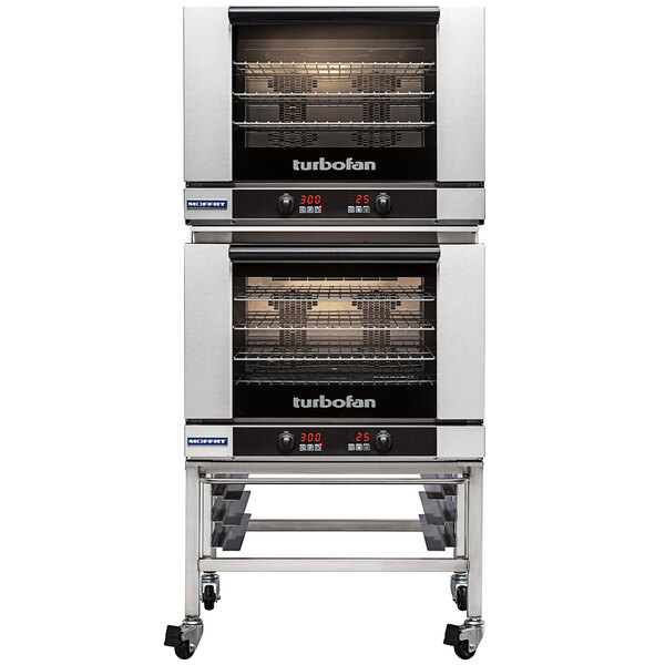 A Moffat Turbofan double deck electric convection oven on wheels with shelves inside.