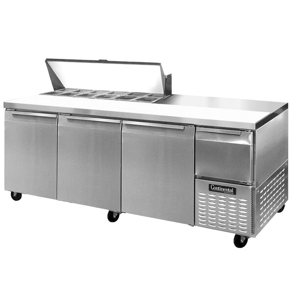 A stainless steel Continental Refrigerator with three doors and one half door on a counter.