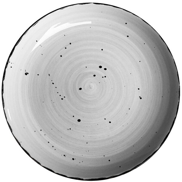 A white International Tableware Rotana porcelain plate with black specks.