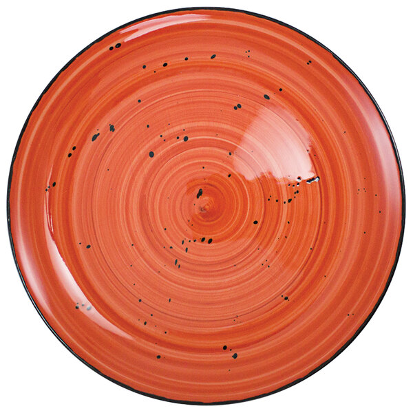 A red porcelain plate with black specks.