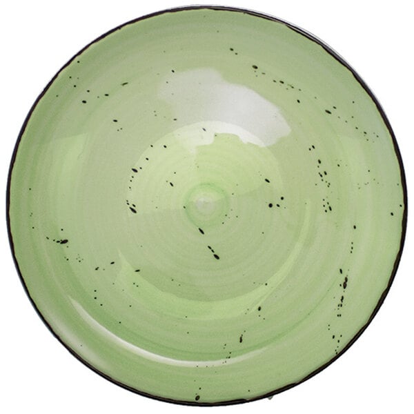 A lime green porcelain pasta bowl with black specks on the surface.