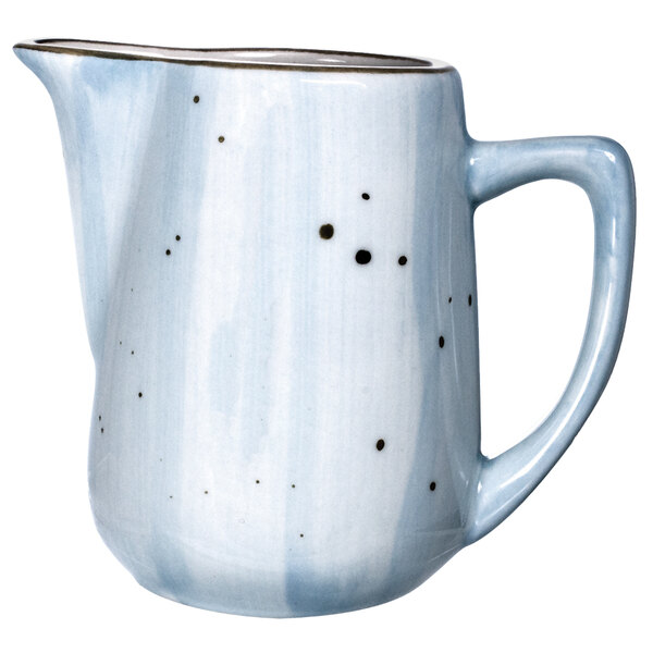 A white porcelain pitcher with a blue speckled design.