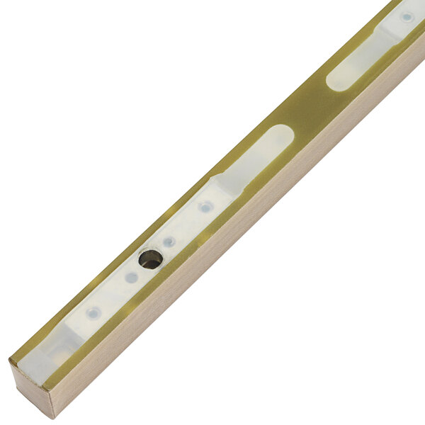 A gold metal light bar with two holes in it.