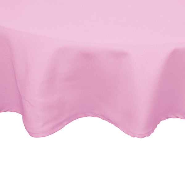 A pink hemmed Intedge cloth table cover on a table with a white background.