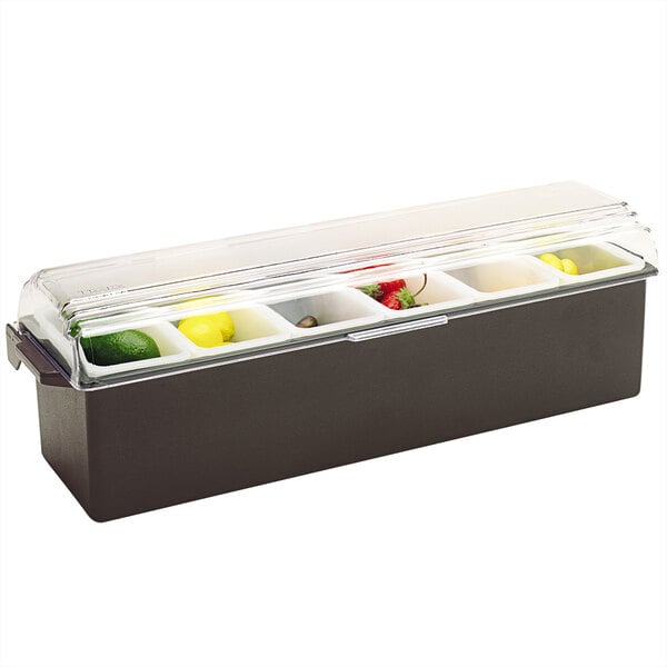 A black Vollrath condiment bar with fruit in containers on a counter.