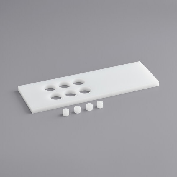 A white plastic tray with holes and small round bumpers.