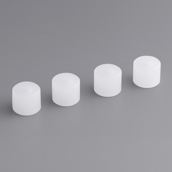 A row of white cylindrical caps with round tops.