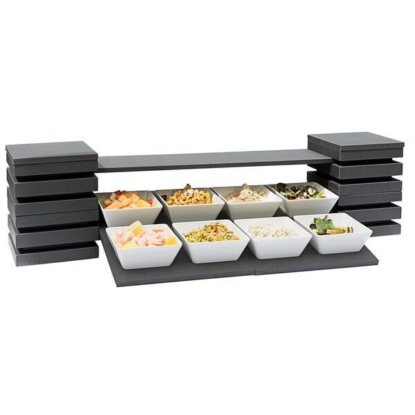A white Vollrath modular display with food in bowls on a table.