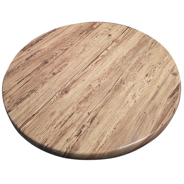 An American Tables & Seating round wooden table top with a circular design on a table.