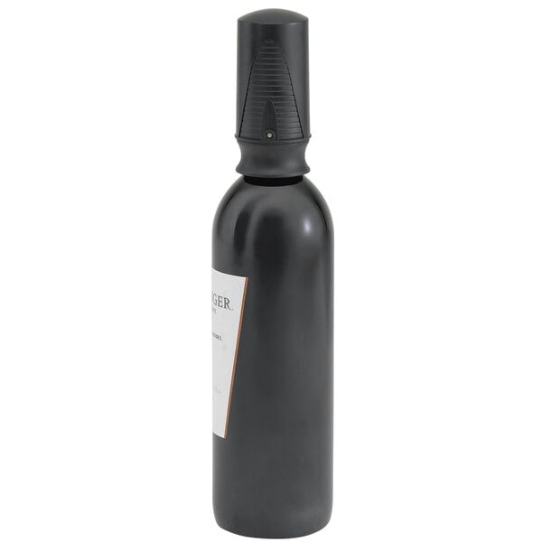 A black Vollrath vacuum wine bottle stopper in a black wine bottle with a white label.