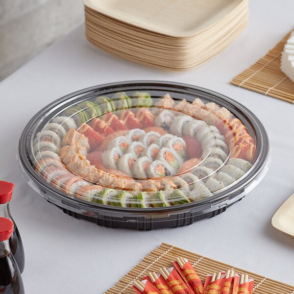 An Emperor's Select sushi tray filled with sushi and other food items on a table.
