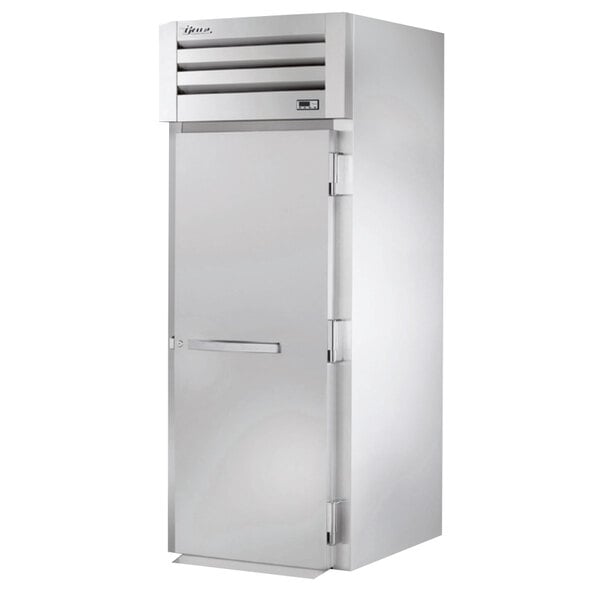 A stainless steel True Spec Series roll-in refrigerator with a solid door.