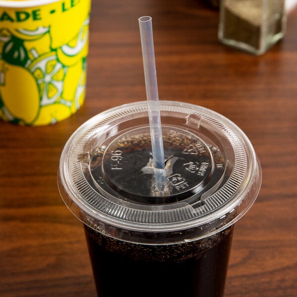 A plastic cup with a clear wrapped straw in it.
