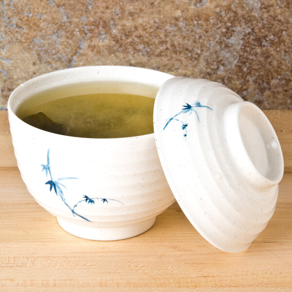 A white melamine miso bowl with a lid and spoon.