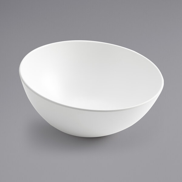 An American Metalcraft white slanted melamine bowl on a gray surface.