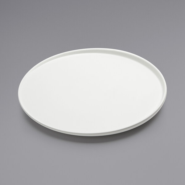 An American Metalcraft white melamine plate on a gray surface.