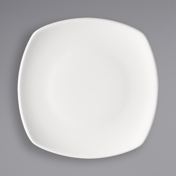 A white square Bauscher porcelain plate with a white rim.