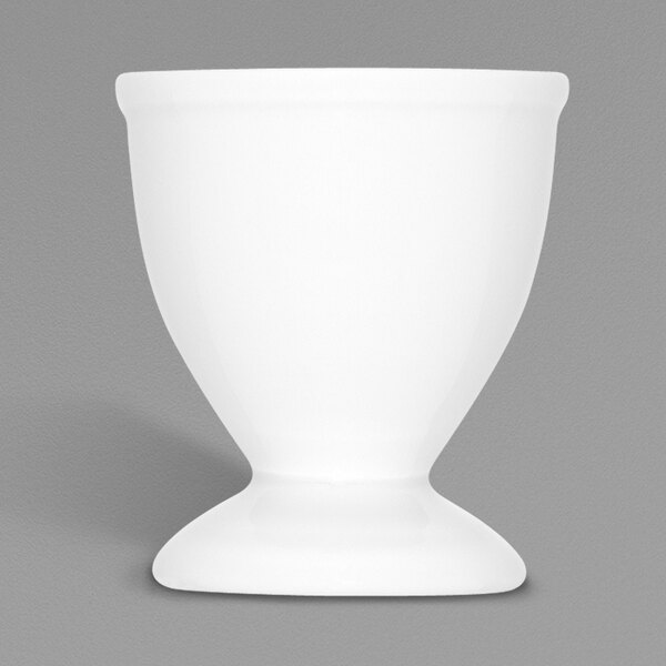 A white Bauscher egg cup on a gray background.