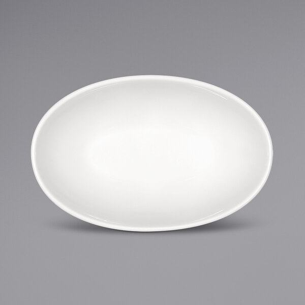 A Bauscher bright white porcelain oval bowl on a gray surface.