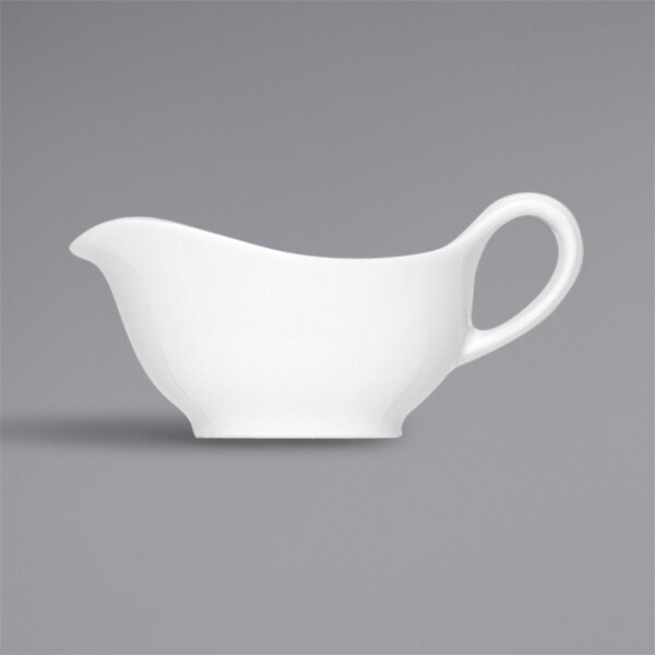 A Bauscher bright white porcelain gravy boat with a white handle.