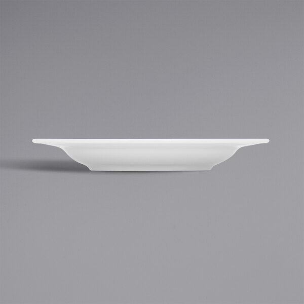 A Bauscher bright white porcelain deep plate with a wide rim.