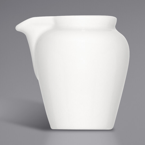 A Bauscher bright white porcelain creamer with a handle.