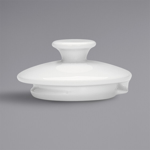 The lid for a white Bauscher porcelain teapot with a round top.