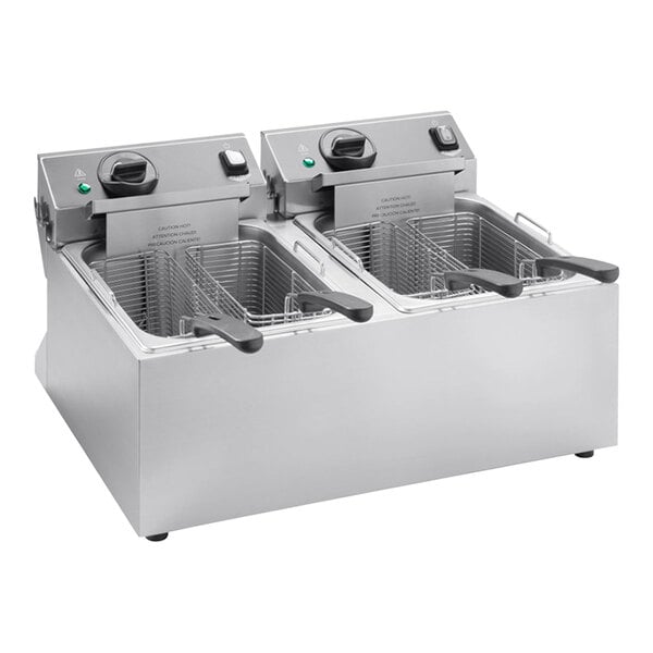A Vollrath commercial countertop deep fryer with two pots and two baskets.