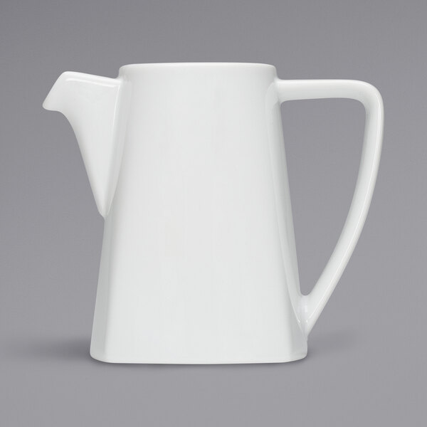 A white coffee pot with a handle.