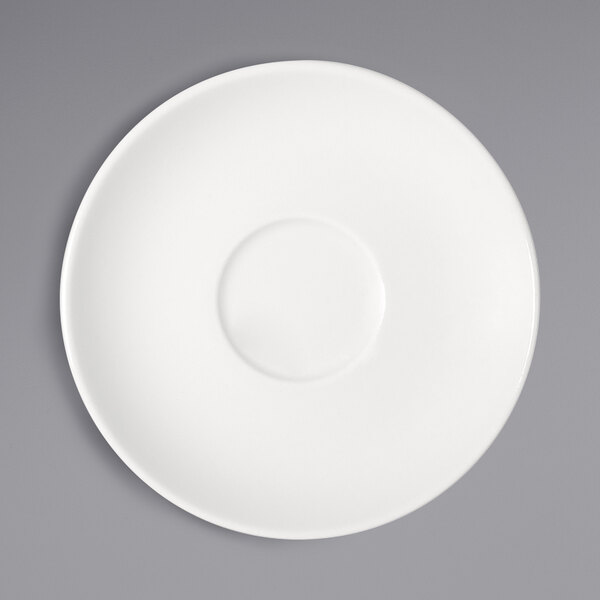 A Bauscher bright white porcelain saucer with a circle in the middle on a gray surface.