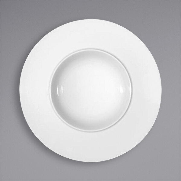A Bauscher bright white porcelain deep plate with a wide white rim.