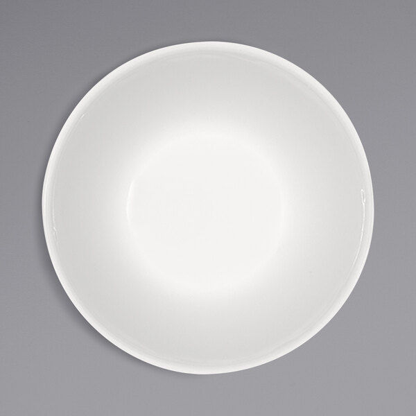 A Bauscher bright white porcelain bowl on a gray surface.
