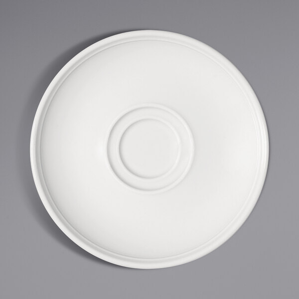 A bright white porcelain saucer with a circular rim and circle in the middle.