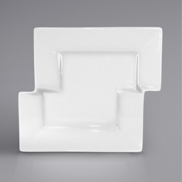 A white porcelain square plate with a square cut out.