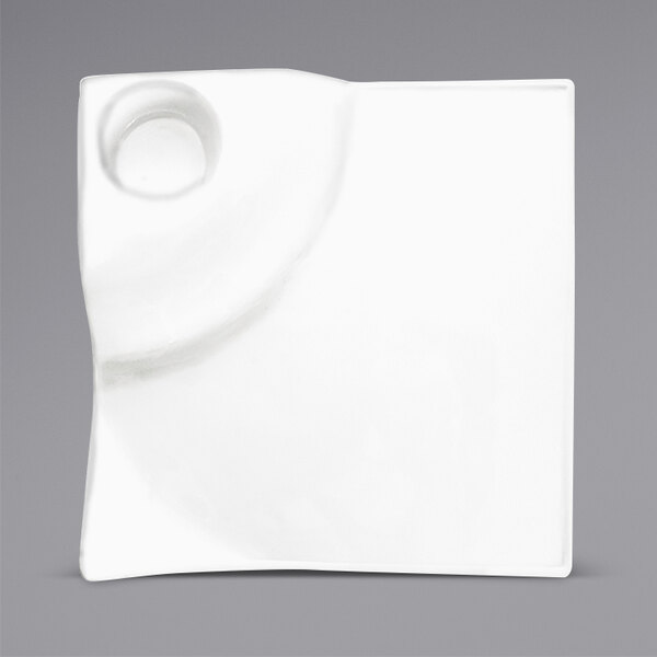 A white square porcelain plate with a circle in the middle.