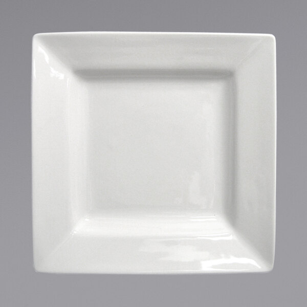 A close-up of an International Tableware bright white square porcelain plate with a small rim.