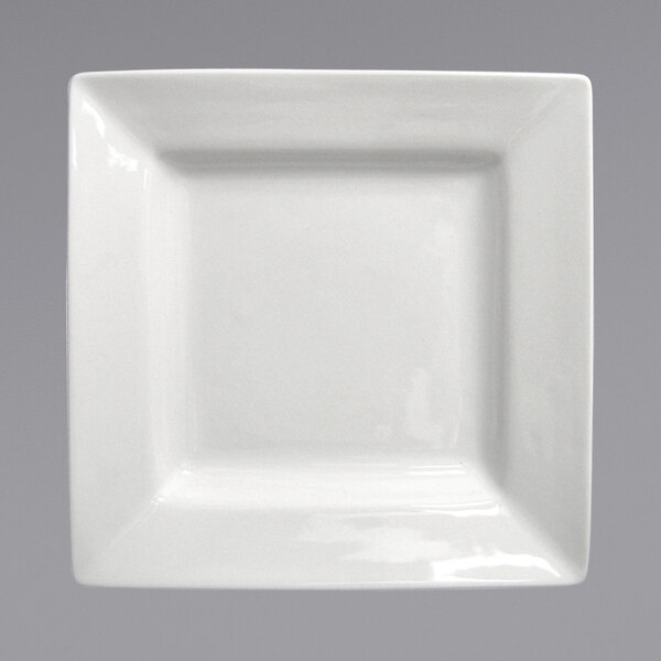 A close-up of a white square International Tableware porcelain plate with a small rim.