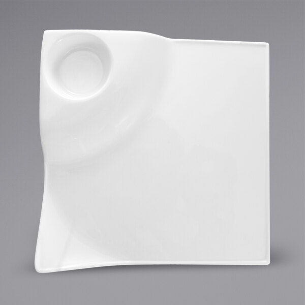 A white square International Tableware porcelain plate with a small circular well in the center.