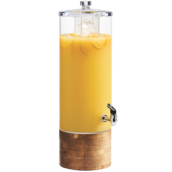 A Cal-Mil Madera beverage dispenser with ice chamber and a rustic wood base filled with orange juice.