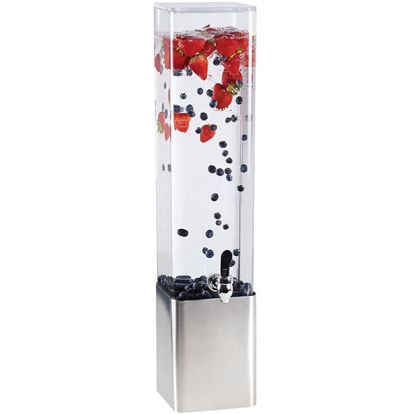 A Cal-Mil square plastic beverage dispenser with a stainless steel base filled with water, berries, and seeds.