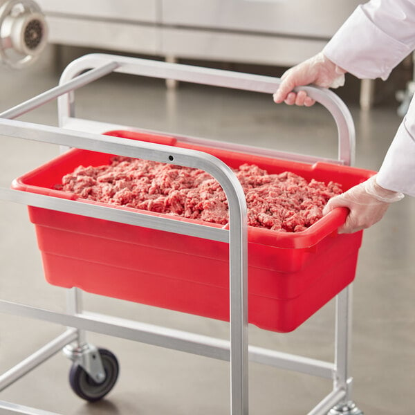 A person holding a red Choice meat tote full of ground meat.