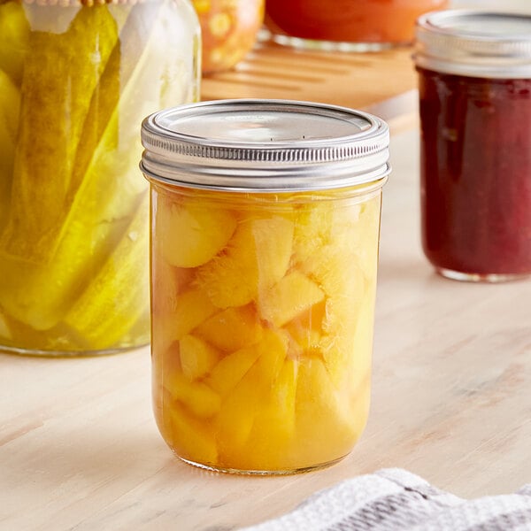 A Choice wide mouth canning jar filled with canned fruit.
