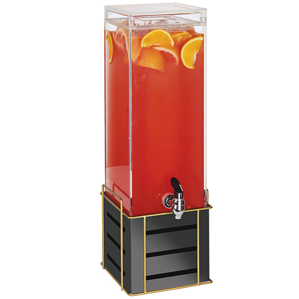 A Cal-Mil beverage dispenser with a black and gold metal base and oranges in the tap.