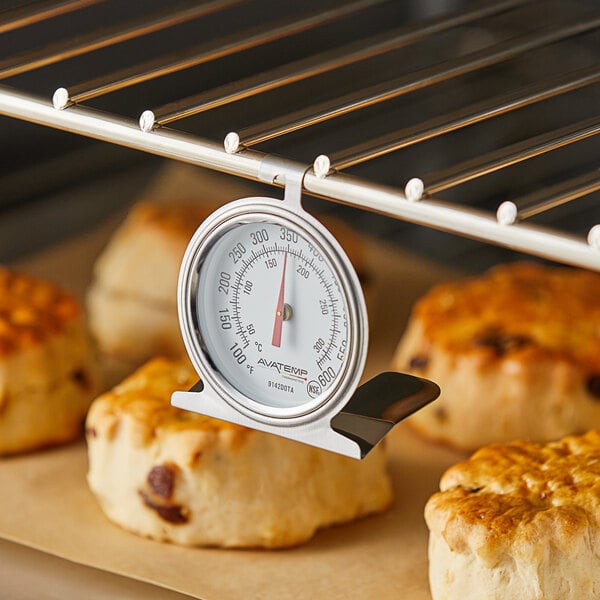 An AvaTemp oven thermometer on a rack of baked goods.